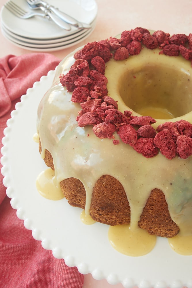 White Chocolate Raspberry Bundt Cake on a white cake stand