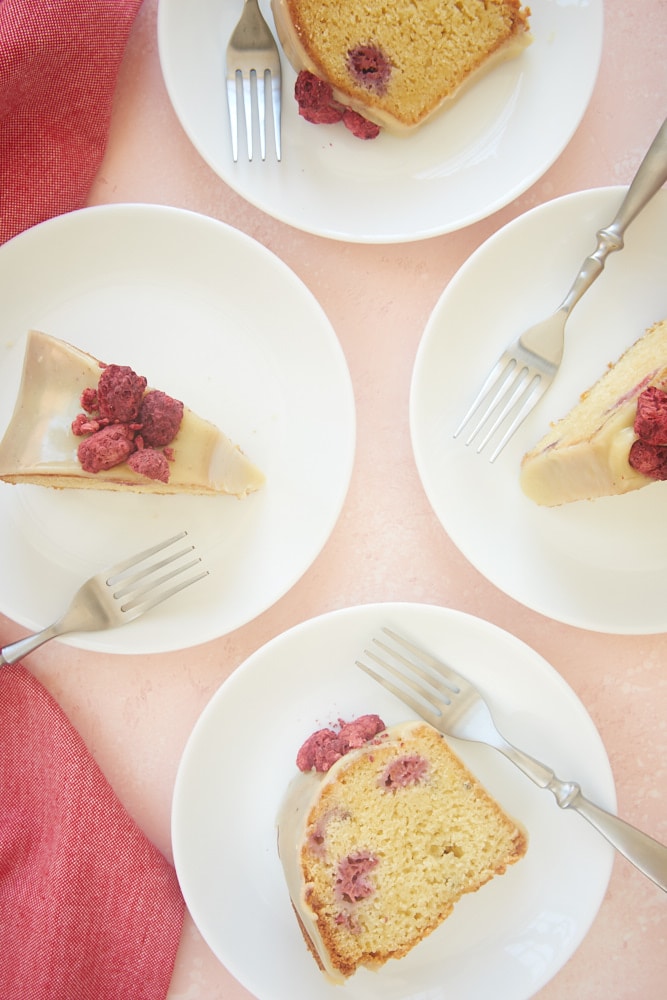 White Chocolate Raspberry Bundt Cake slices served on white plates