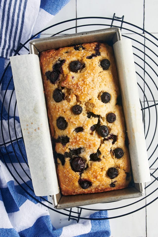 Baked blueberry bread in a loaf pan.