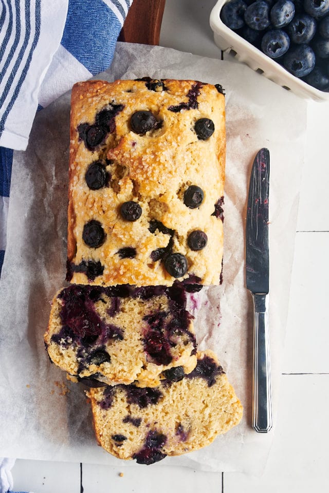 A loaf of blueberry bread cut into slices.