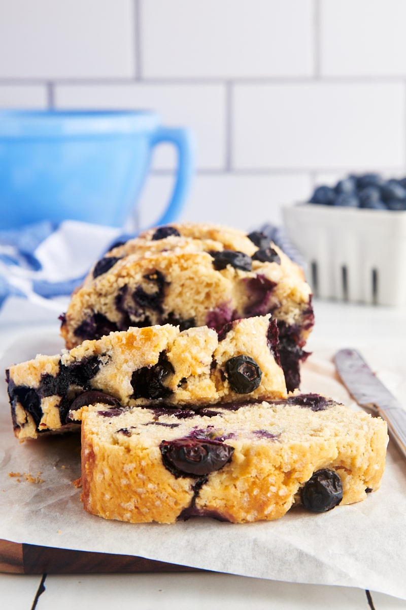 Slices of blueberry loaf on a countertop.