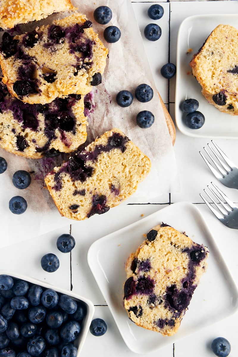 Blueberry loaf slices with fresh blueberries.