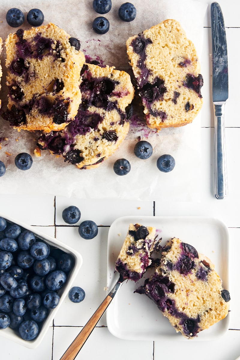 Blueberry loaf next to a bunch of fresh blueberries.