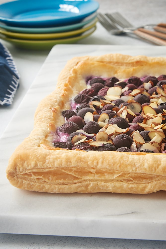 Blueberry Cream Cheese Tart on a marble serving board