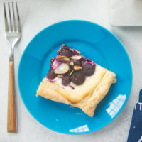 Blueberry Cream Cheese Tart served on a blue plate