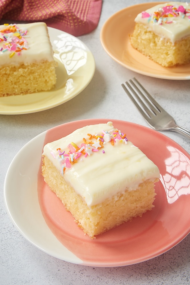 slices of Lemon Sheet Cake on colorful plates