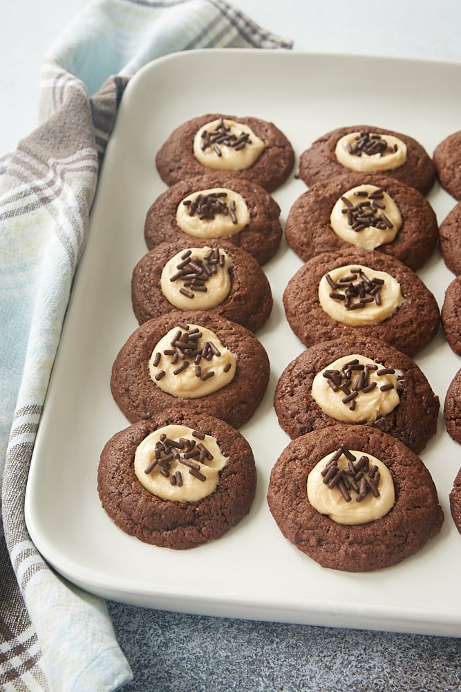 a white tray filled with Chocolate Peanut Butter Thumbprint Cookies