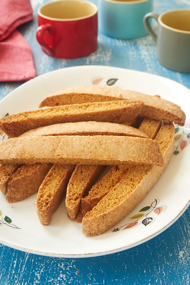 Easy Vanilla Biscotti stacked on a white plate with a floral rim