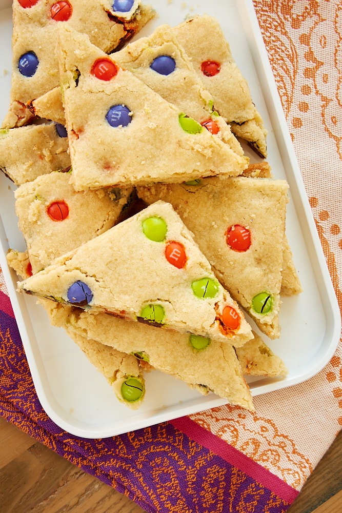 M&M sugar cookie bars on a white tray.