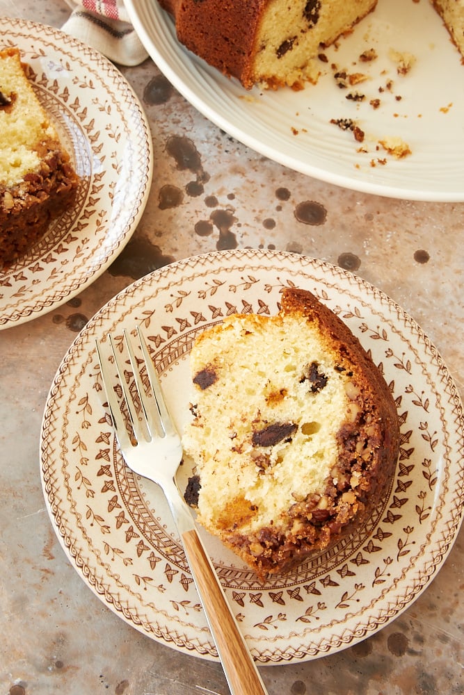 slice of Chocolate Chunk Pecan Crunch Cake on a brown patterned plate