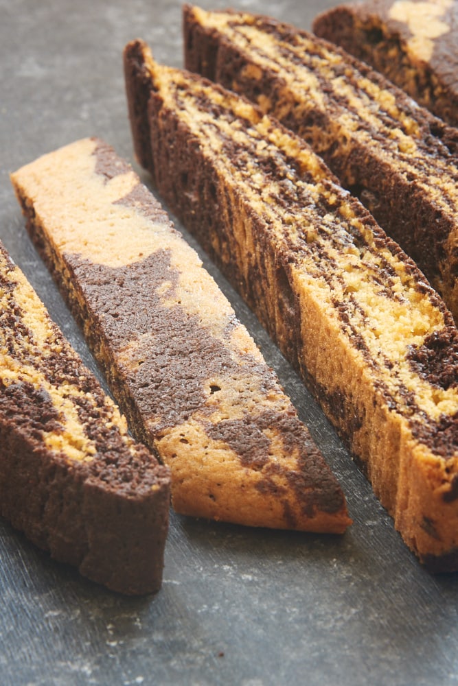 sliced Chocolate Vanilla Marbled Biscotti on a dark surface