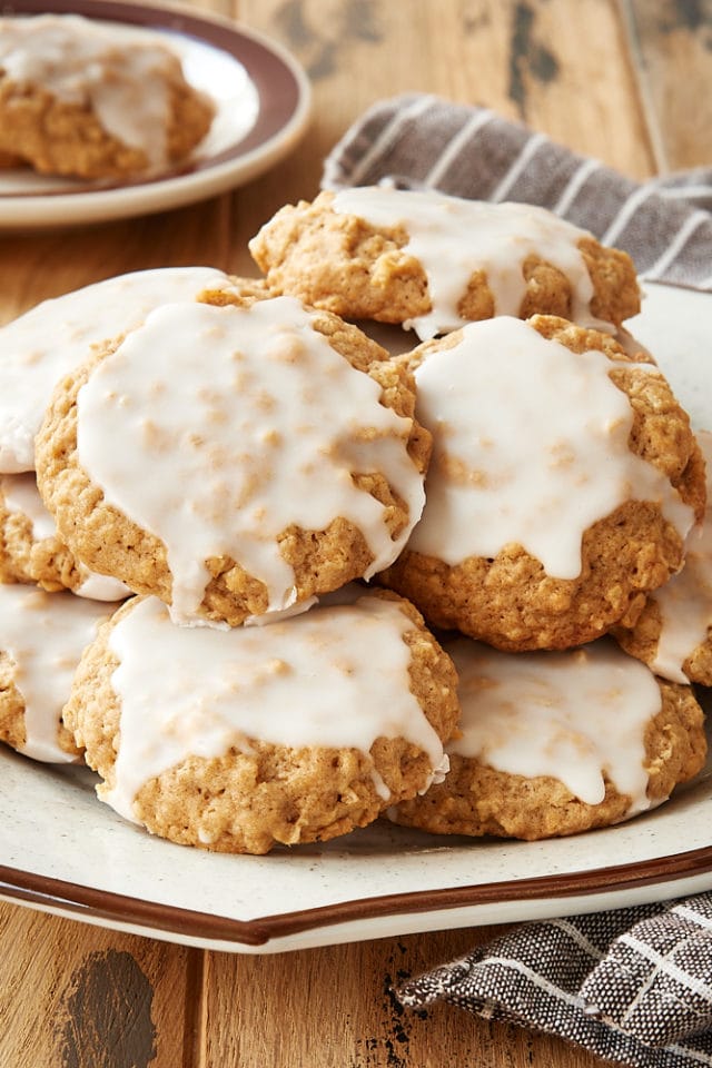Spiced Oatmeal Cookies stacked on a brown-rimmed plate