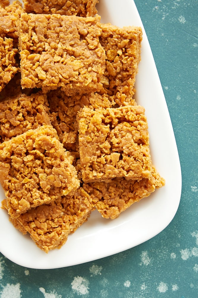 Peanut Butter Corn Flake Bars stacked on a white tray