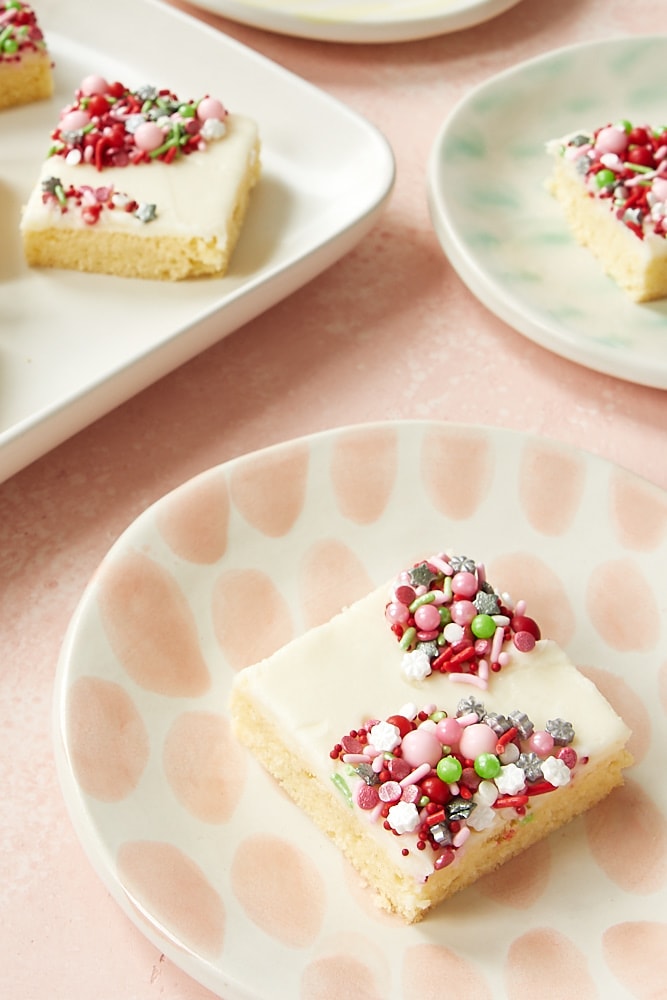 Peppermint sugar cookie bars on colorful plates.