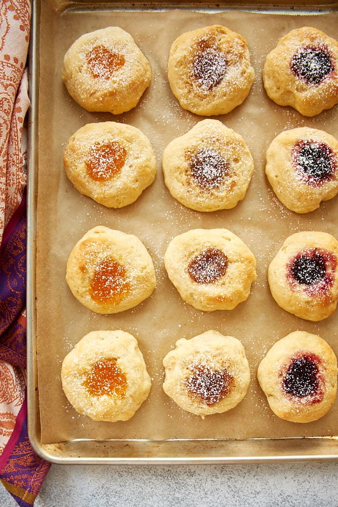 Overhead view of kolaches on a parchment-lined baking sheet