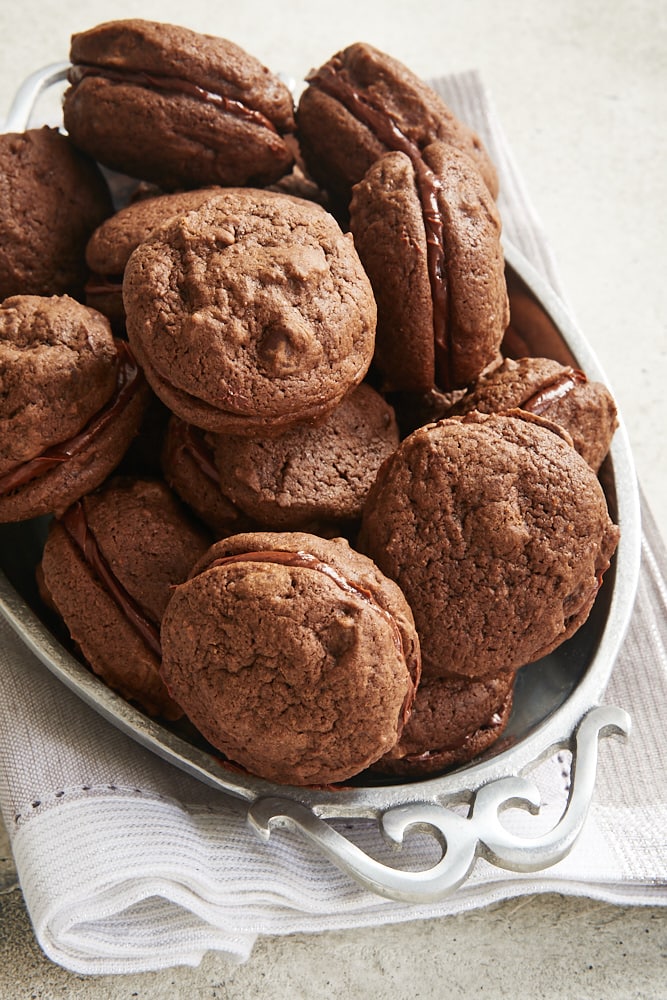 Double Chocolate Sandwich Cookies stacked in a pewter bowl