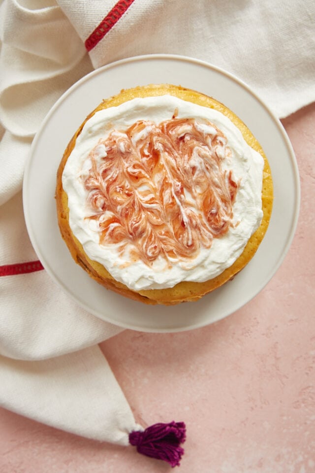Vanilla Bean Cheesecake for Two topped with strawberry-swirled whipped cream