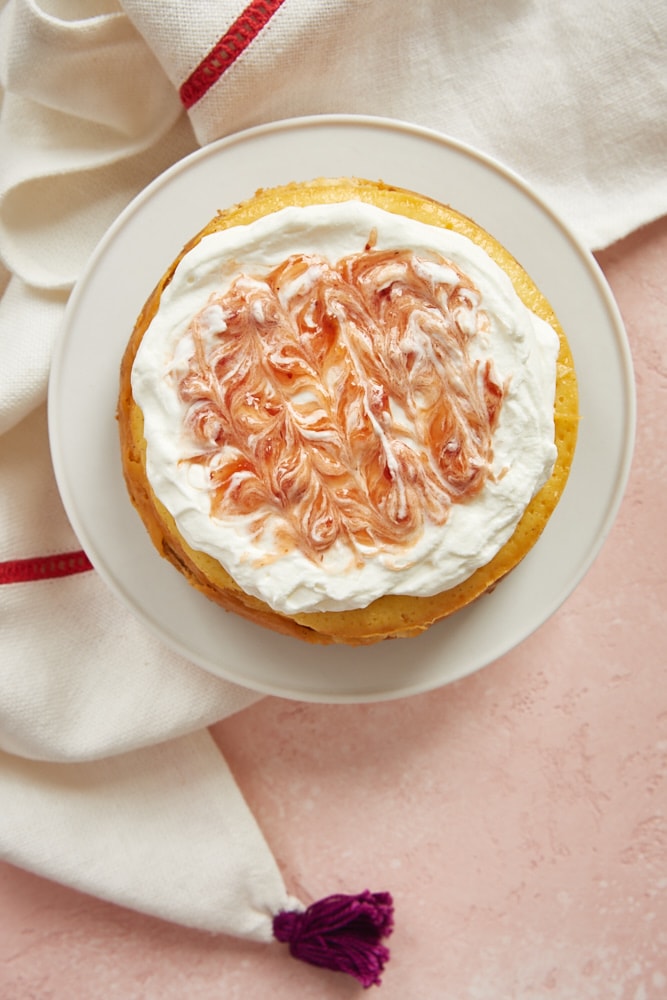 Vanilla Bean Cheesecake for Two topped with strawberry-swirled whipped cream