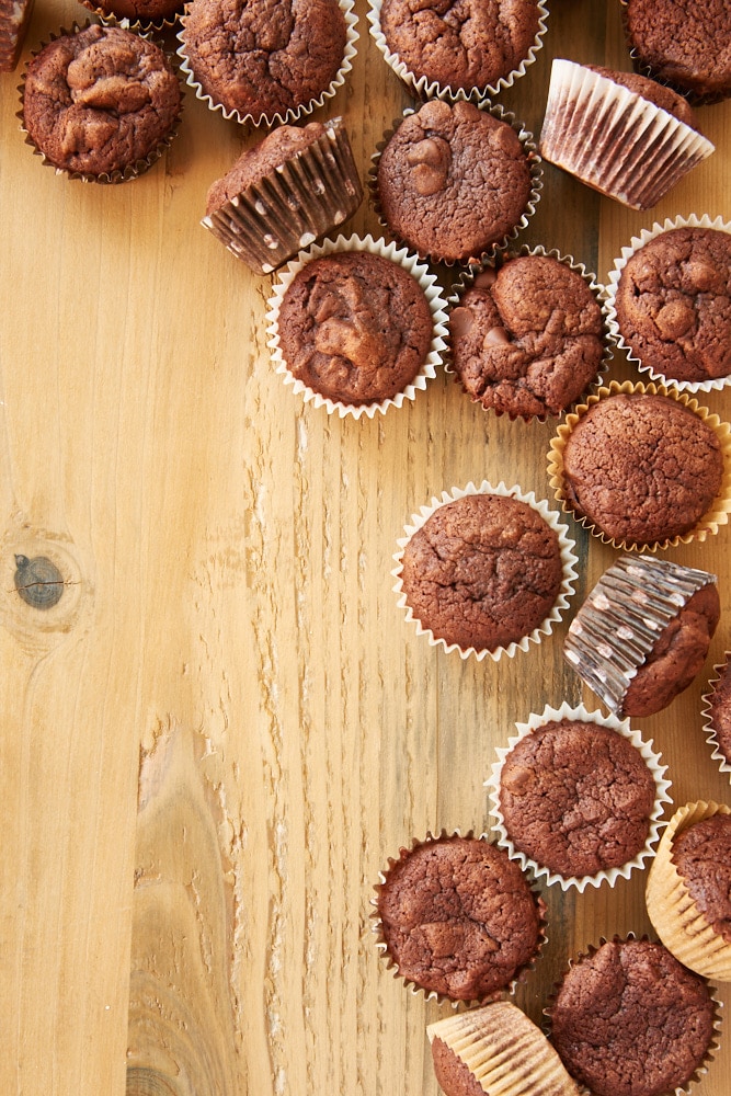 Irish cream brownie bites scattered on the right side of a wooden surface