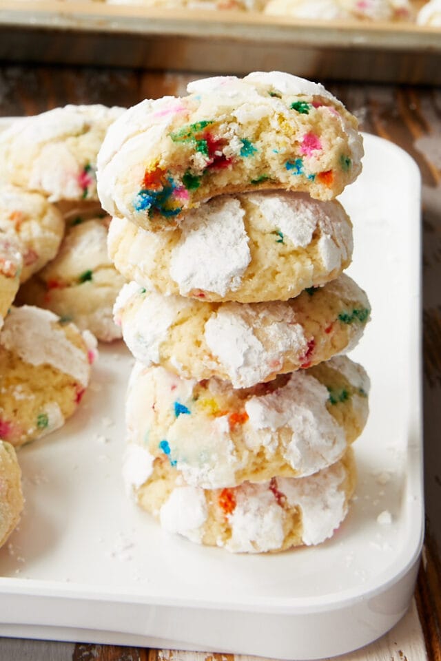stack of Sprinkle Crinkle Cookies on a white tray