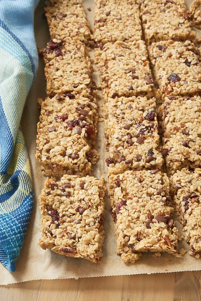 Cranberry Chocolate Chip Pecan Granola Bars on a sheet of parchment paper