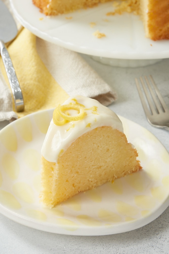 slice of Lemon Bundt Cake on a white and yellow plate