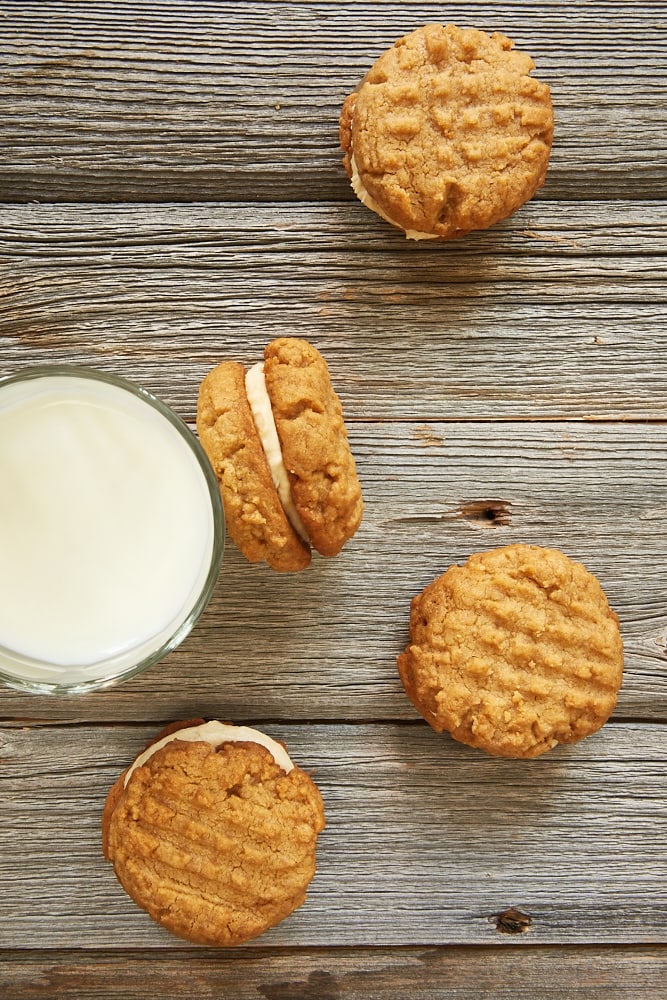 peanut_butter_sandwich_cookies on a pale wooden surface