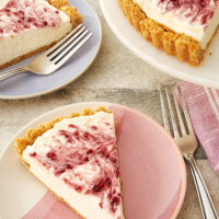 slice of No-Bake Raspberry Cheesecake on a pink and white plate