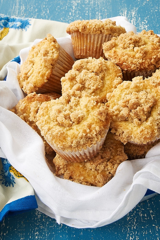 Vanilla Crumb Muffins in a towel-lined metal basket