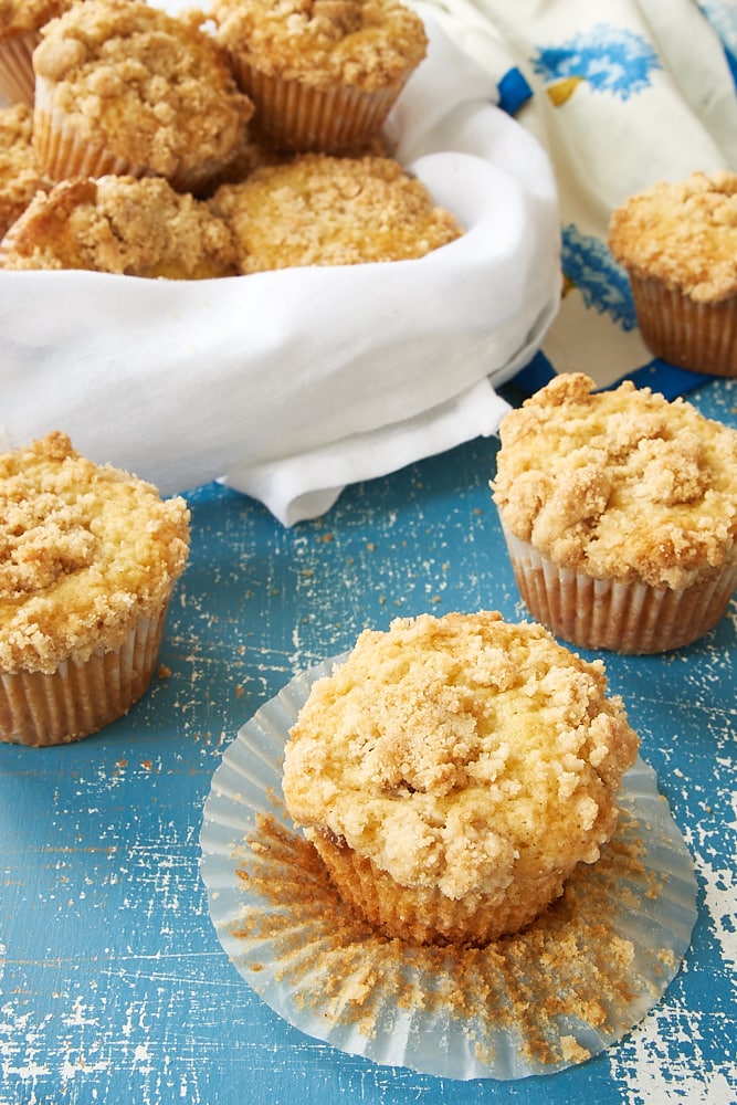 a partially unwrapped Vanilla Crumb Muffin surrounded by more muffins