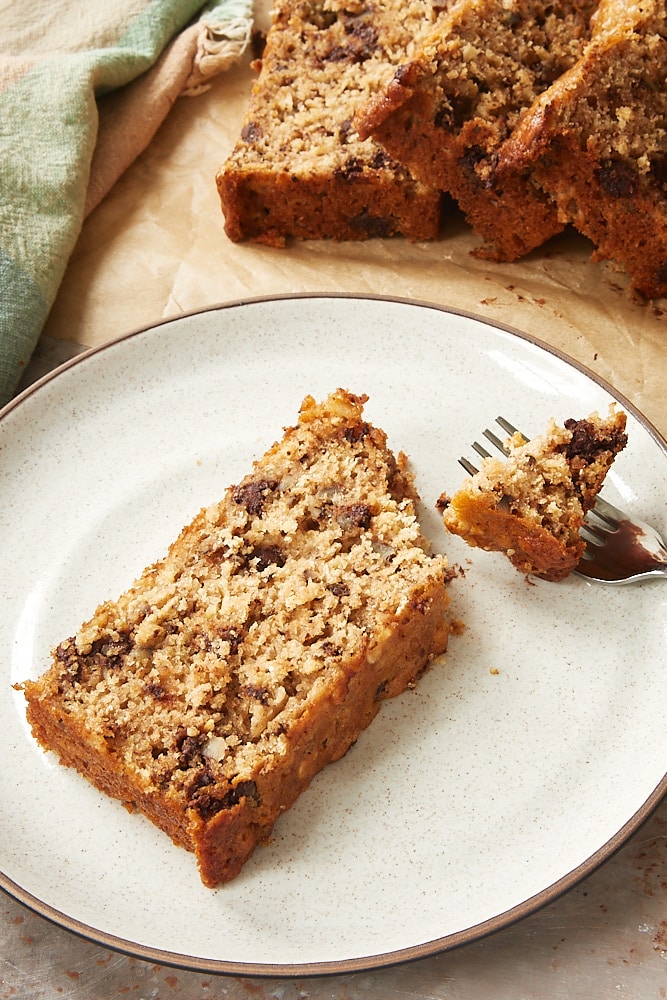 slice of Chocolate Chip Oatmeal Quick Bread on a brown-speckled white plate