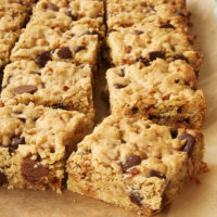 Loaded Chocolate Chip Cookie Bars on parchment paper