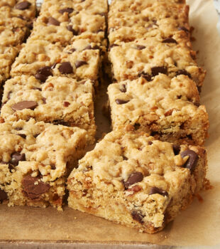 Loaded Chocolate Chip Cookie Bars on parchment paper