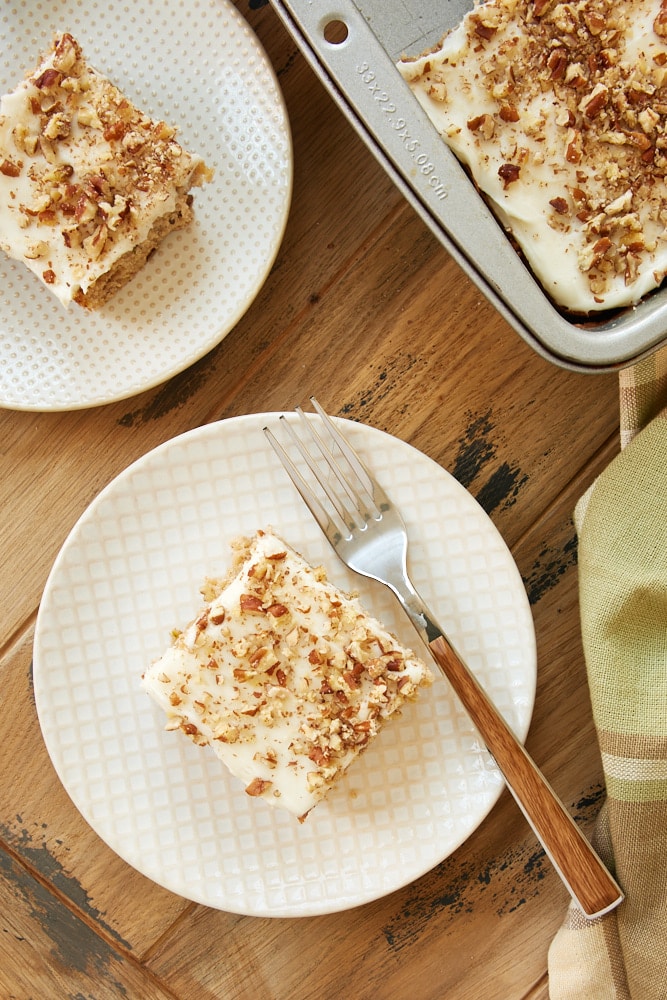 overhead view of Frosted Zucchini Bars on white and beige plates