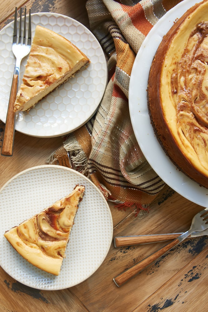 overhead view of slices of Apple Butter Cheesecake on white and beige plates