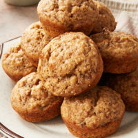 Cinnamon Pecan Muffins on a white and brown speckled plate.