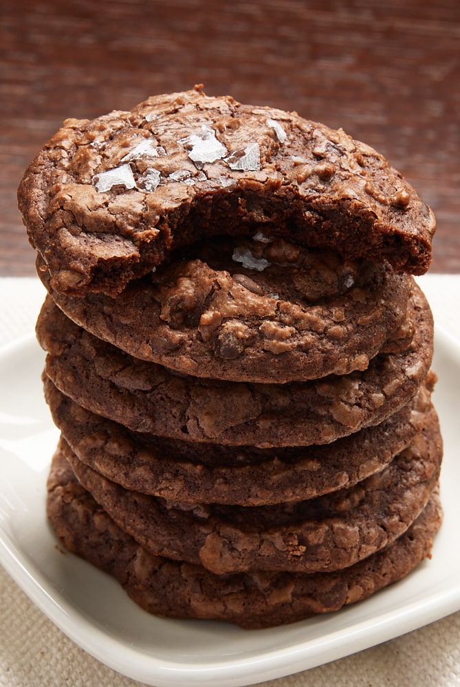 partially eaten Salted Chocolate Truffle Cookie on top of a stack of cookies