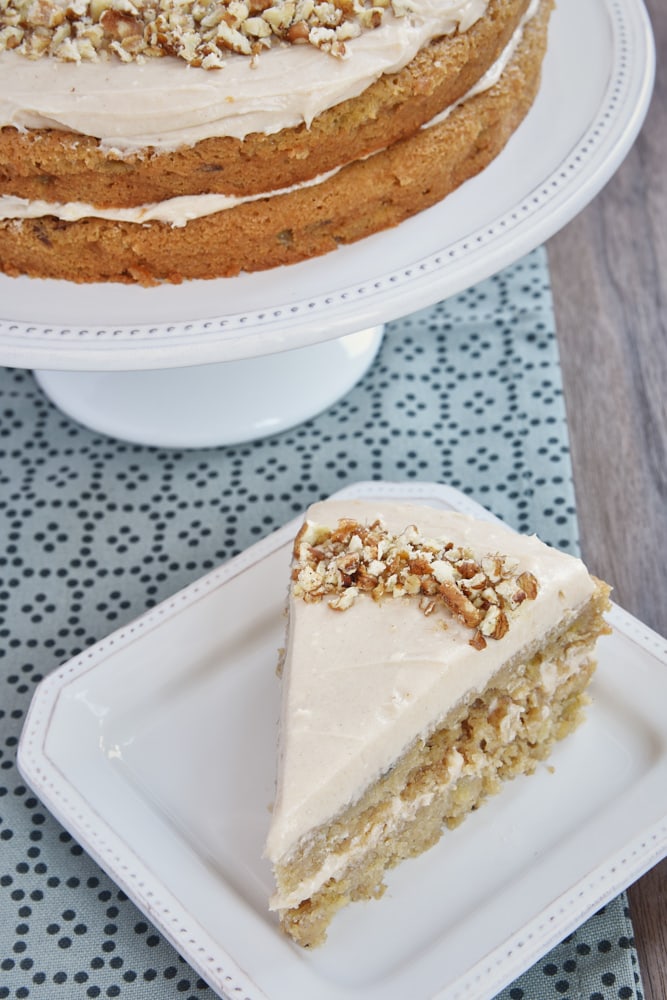 slice of Apple Spice Cake with Cinnamon Cream Cheese Frosting on a white plate