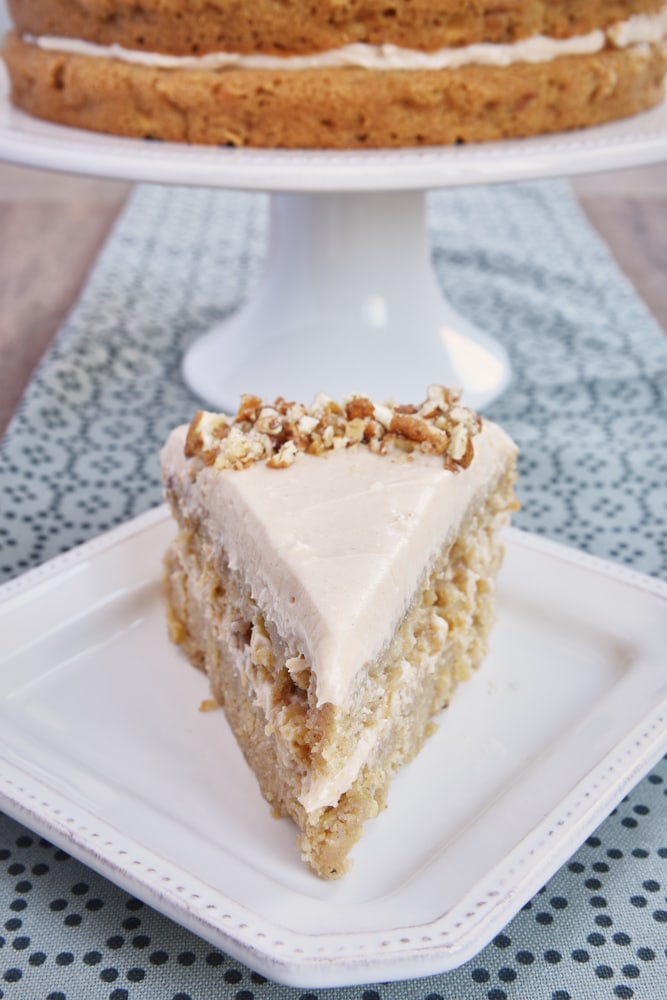 Apple Spice Cake with Cinnamon Cream Cheese Frosting on a square white plate