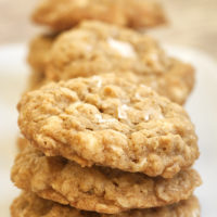 Salted Vanilla Chip Oatmeal Cookies stacked on a white plate