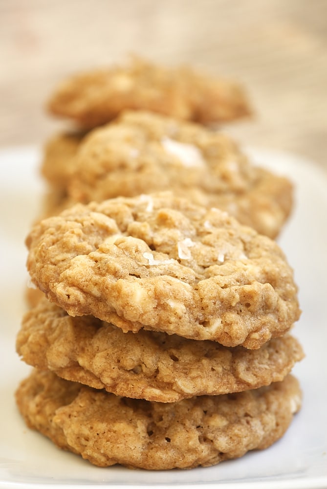 Salted Vanilla Chip Oatmeal Cookies stacked on a white plate