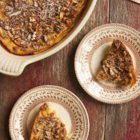 overhead view of Apple Bourbon Clafoutis served on brown-rimmed floral plates