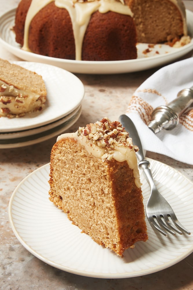 Brown Sugar Spice Cake with Caramel Rum Glaze served on white and beige plates