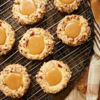 overhead view of Caramel Pecan Thumbprint Cookies on a wire rack