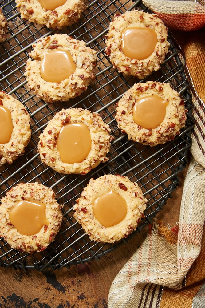 overhead view of Caramel Pecan Thumbprint Cookies on a wire rack