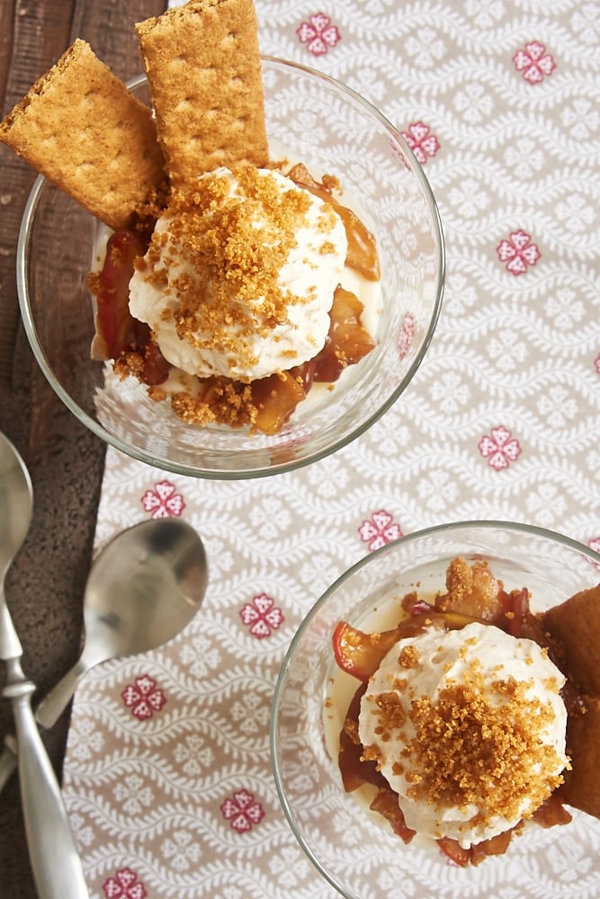 overhead view of individual No-Bake Apple Cheesecakes on a gray and red printed fabric