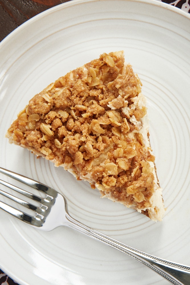 overhead view of a slice of Pear Crisp Cheesecake on a pale gray plate