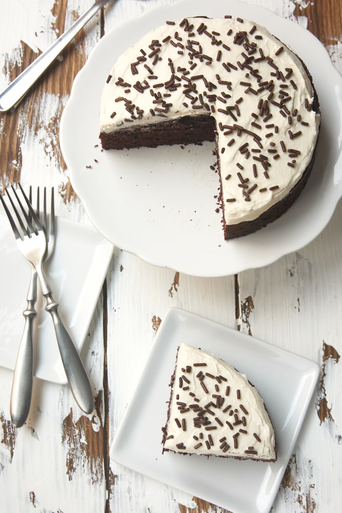 overhead view of 6-Inch Chocolate Cake with Marshmallow Frosting on a white cake stand and on a white plate