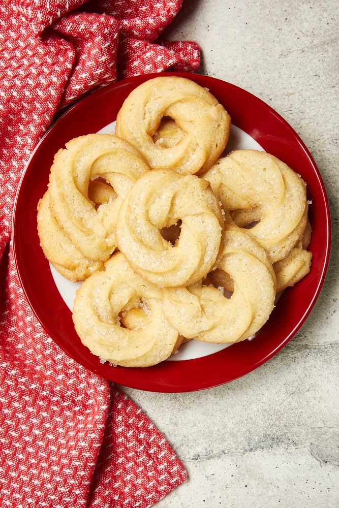 overhead view of Danish Butter Cookies on a red-rimmed white plate