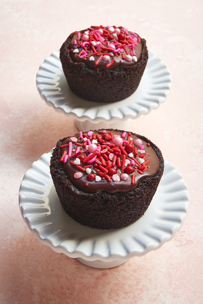 Chocolate Cupcakes for Two on small cake stands on a pink surface